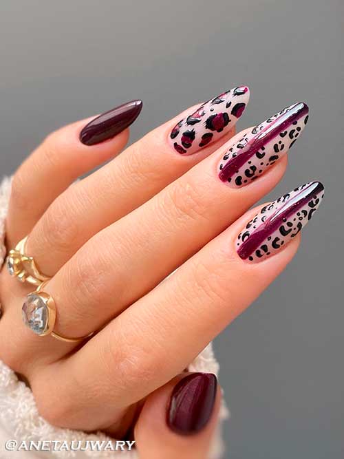 Elegant burgundy fall nails with leopard prints Long almond shaped burgundy fall nails with leopard prints