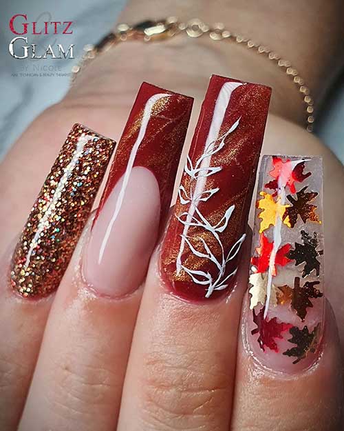 Long square shaped Brown fall nails with maple leaves and gold glitter Long square shaped Brown fall nails with maple leaves and gold glitter