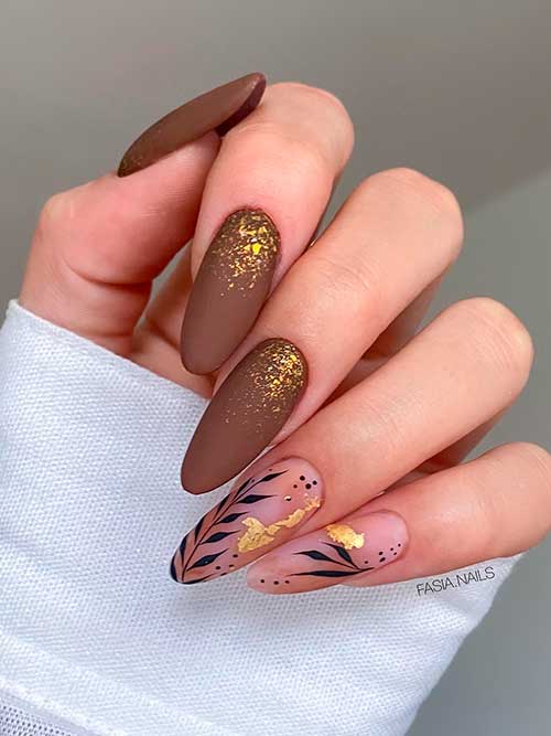 Matte brown nail design with gold glitter, gold foil, and leaf nail art