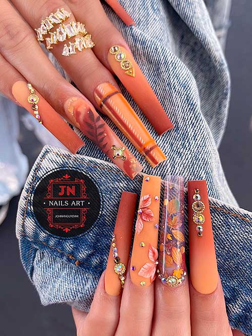 Long coffin shaped matte ombre brown fall nails with maple leaf nail art design with rhinestones
