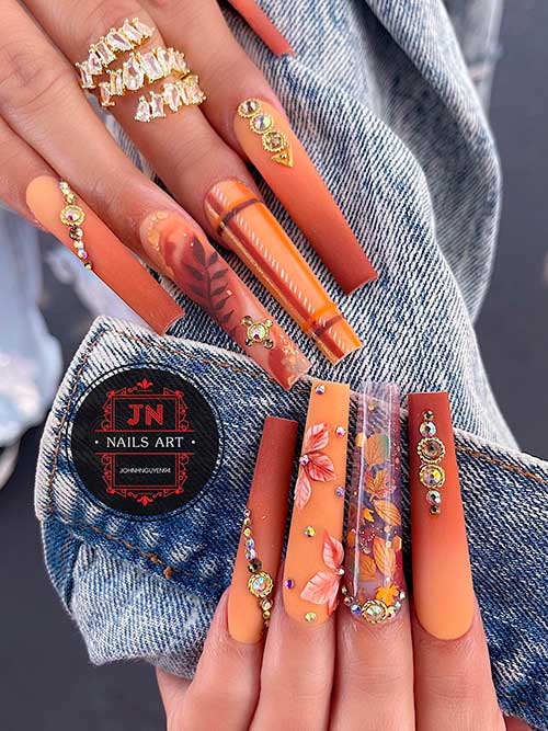 Matte ombre brown fall nails with maple leaf nail art design Long coffin shaped matte ombre brown fall nails with maple leaf nail art design with rhinestones