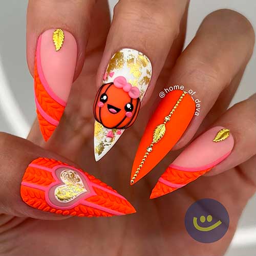 Stiletto pumpkin nails with gold leaf nail art Stiletto pumpkin nails with gold leaf and sweater nail art