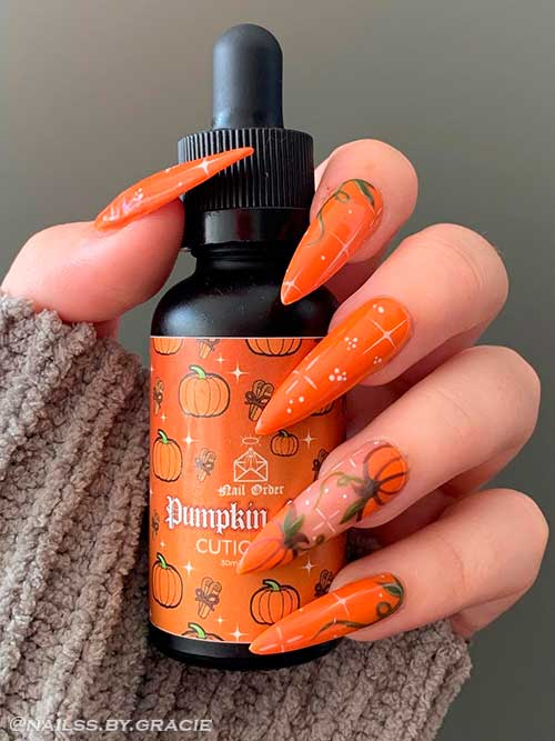 Long stiletto shaped Witch and pumpkin nail art design for Halloween 2022