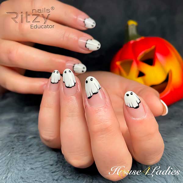 Cute Ghost Nails Consist of White Ghosts on the Tips and Nude Base Color for Halloween 2022