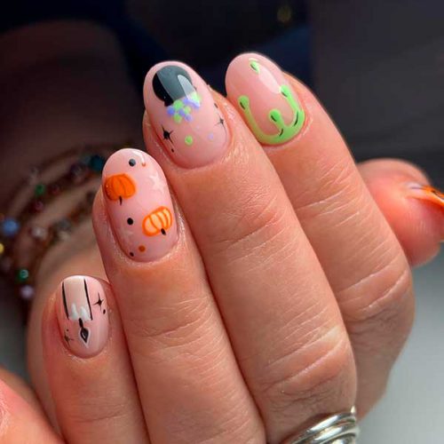 Cute Simple Halloween Nails with Nude Base Color and Different Halloween Themes