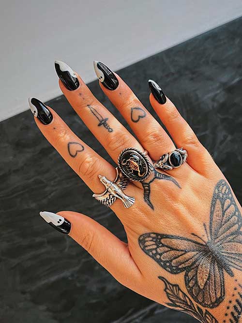 Glossy black nails with white ghosts Glossy black nails with white ghosts - Halloween Ghost Nails Ideas