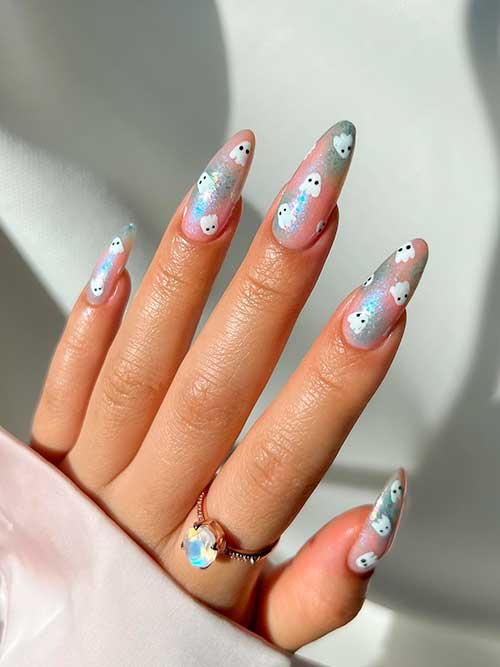 Long Almond Shaped Holo Ghost Nails Consists of White Little Ghosts on Nude Nails with Holo Patches