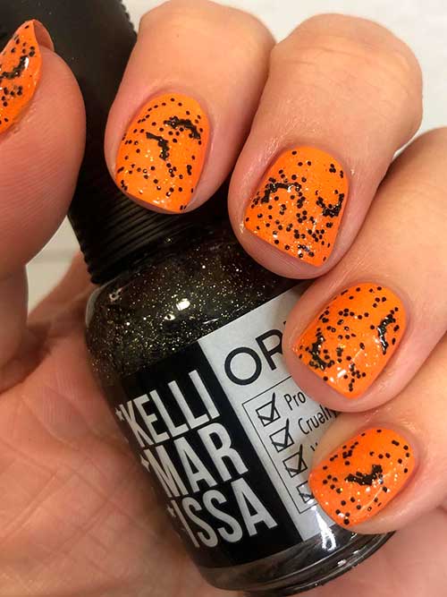 Short Orange Halloween Nails 2022 with Orly Wing It Topper which Combines Bat Shaped Confetti Glitter