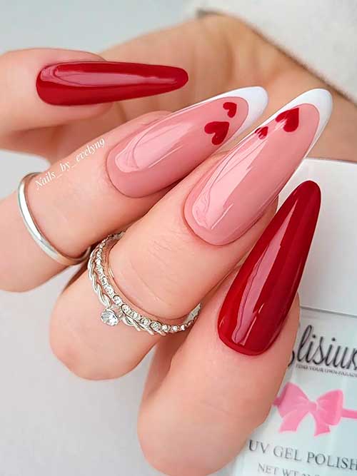 Long almond-shaped dark red valentines nails with white French accents with tiny red hearts