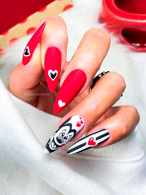 Long almond-shaped matte red valentine’s day nails with black striped and Pluto shape on two white accent nails