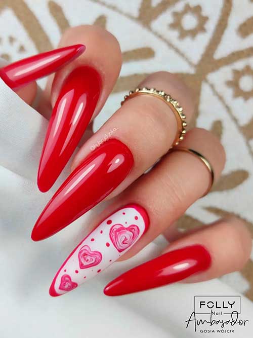 Long almond-shaped red valentine’s nails 2023 with red Hearts and dots on a white accent nail
