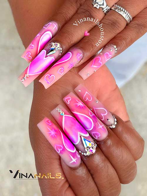 Valentine’s Day Nails with Heart Shapes Long square shaped nude valentine’s day nails with pink purple hearts