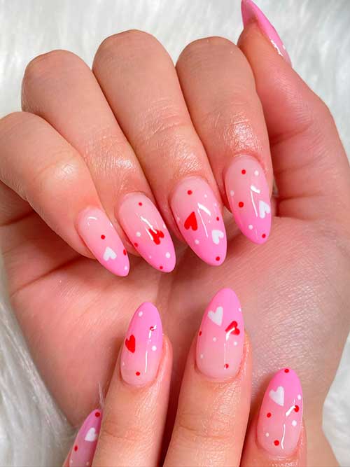 Medium almond shaped ombre pink valentine nails with red and white hearts and polka nail art