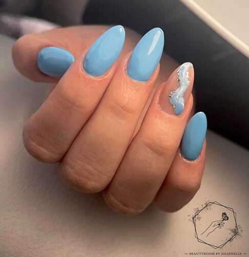 Long almond ocean blue summer nails with marble nail art on an accent nail