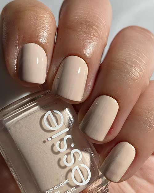 Short milky off-white nails using Essie in My Sandbox from Essie Summer 2023 Collection