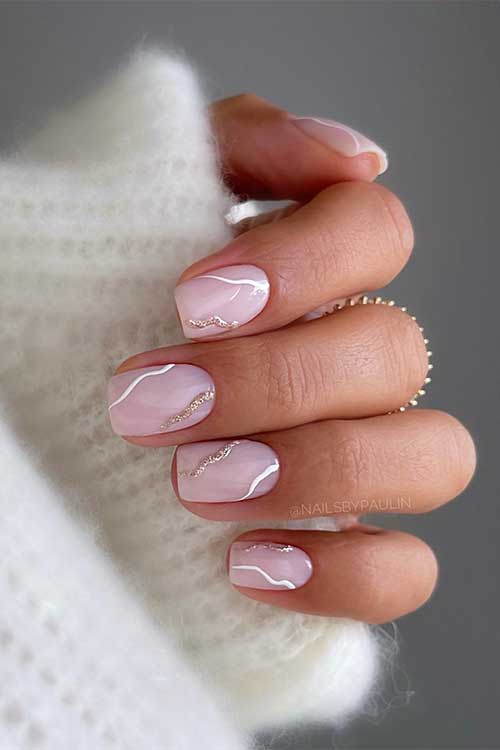 Classy short square shaped nude nails with white and gold glitter swirls Classy short square shaped nude nails with white and gold glitter swirls