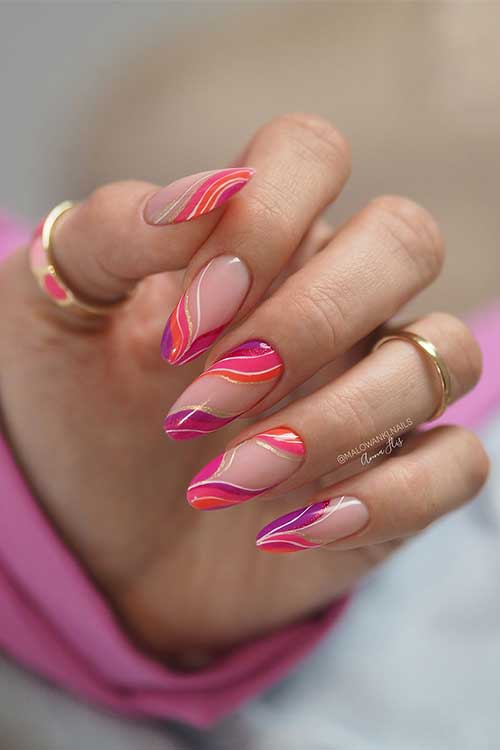Stunning almond shaped nails with swirl nail art features peachy pink, orange, purple, white, and gold glitter swirls
