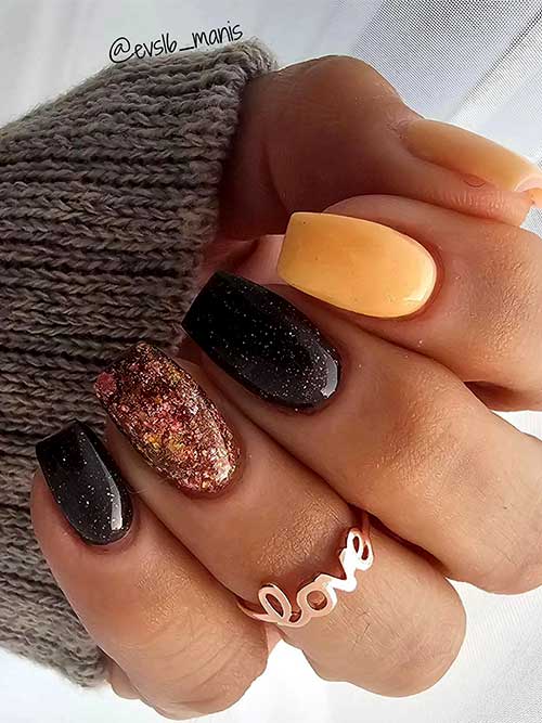 Coffin yellow and black short fall nails adorned with an accent autumn hue glitter nail and a touch of silver glitter