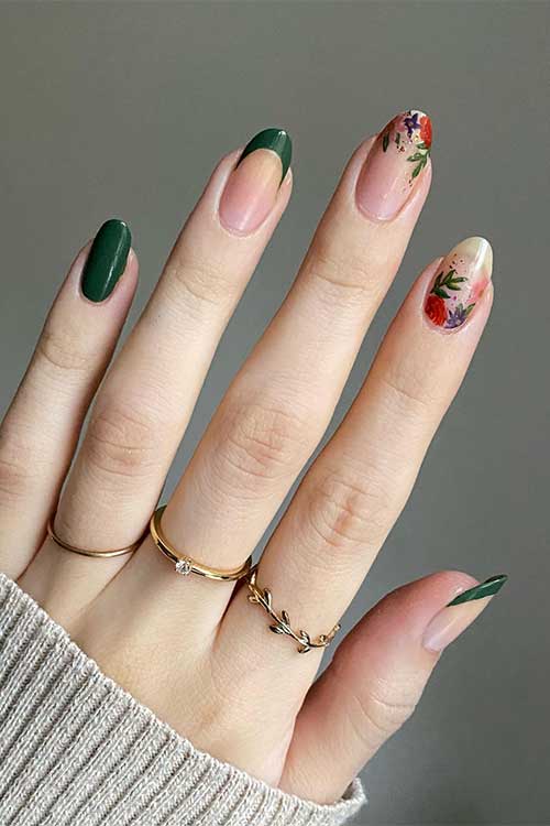 Dark green French tip nails with autumnal floral sets on two accent nude nails.