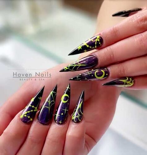Dark purple Stiletto witchy nails with neon yellow celestial nail art and cobwebs Dark purple Stiletto witchy nails with neon yellow celestial nail art and cobwebs