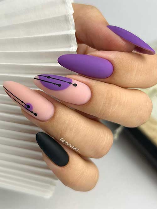 Long almond shaped matte purple nails with a black accent nail and abstract nail art on two accent nude nails.