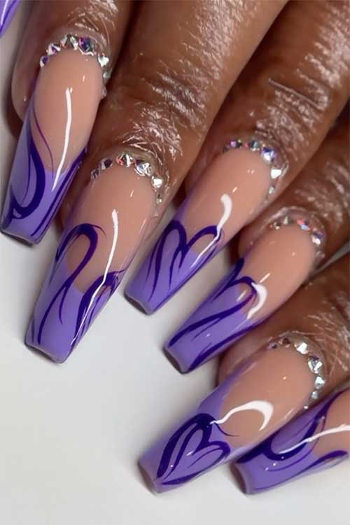 Long coffin French purple nails with dark purple curvy lines as heart shapes and adorned with silver rhinestones.