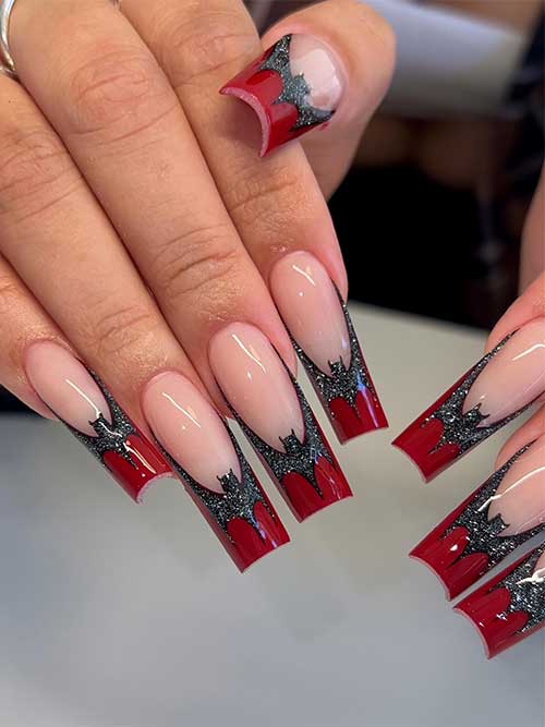 Long dark red French nails with a glitter black bat above each nail tip for Halloween celebration