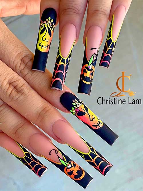 Long matte black French nails with neon yellow and orange cobwebs and pumpkins 