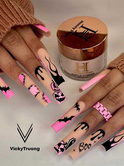 Long matte nude nails with black drip nail art, black flame nail art, and pink French tips, pumpkins, and patches