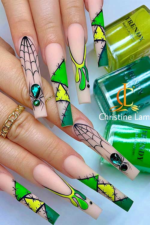 Long nude nails with vibrant green and yellow patches with stitches nail art, drip nail art, cobwebs, and spiders Long nude nails with vibrant green and yellow patches with stitches nail art, drip nail art, cobwebs, and spiders