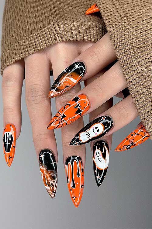Long orange and black Halloween nails with different Halloween nail art ideas such as cobwebs, pumpkins, bats, and ghosts