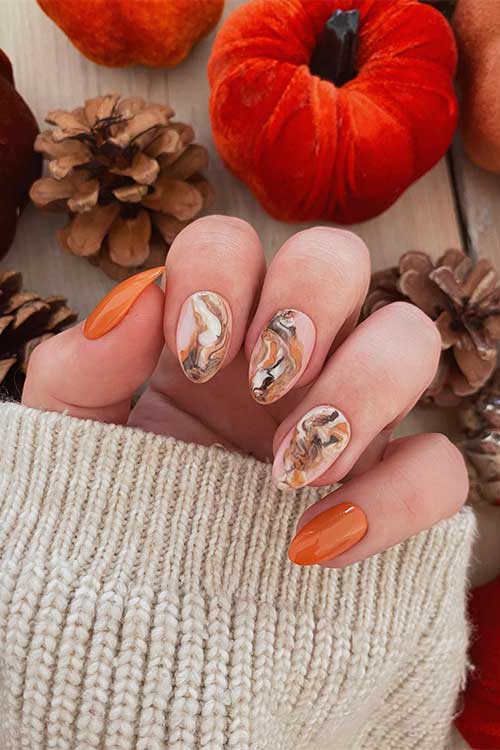 Short Burnt Orange Nails with Burnt Orange, White, and Black Marble Nail Art on Nude Pink Accent Nails