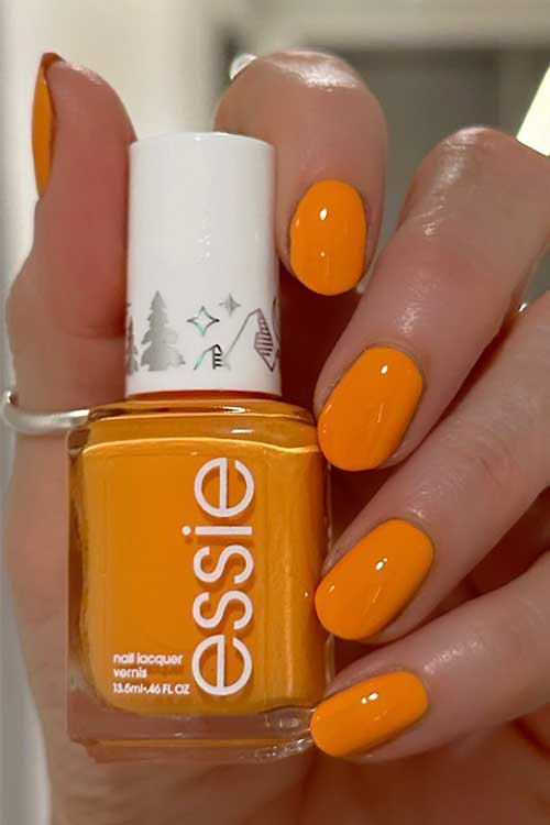 Short Tangerine Orange Nails with Essie Firefly Away from The Essie Mystical Mist Collection