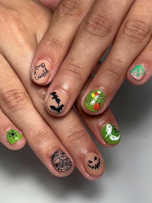 Short glitter green and black Halloween nails with ghosts, bats, and cobwebs Short glitter green and black Halloween nails with ghosts, bats, and cobwebs