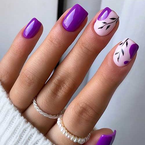 Short square shaped purple fall nails with black leaf nail art on two accent nails.