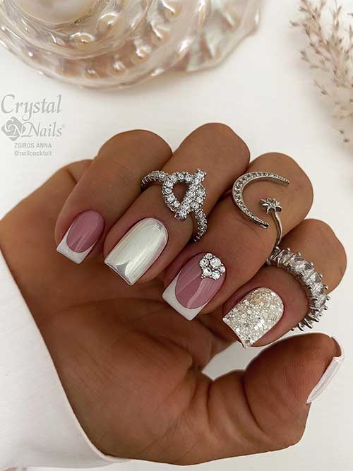 Sparkling short white French nails with rhinestones, silver glitter, and mirror chrome accent nails