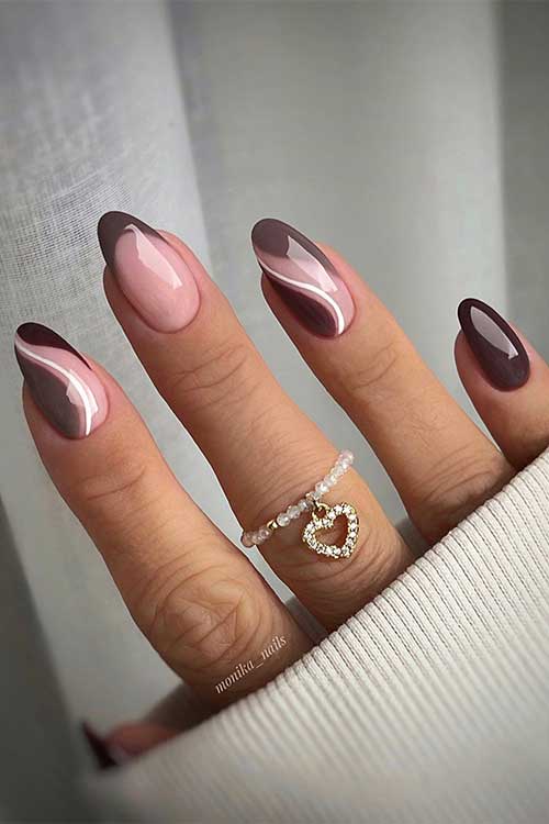Two-tone brown nails with swirl nail art and a French tip on accent nails.