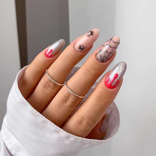 Long Silver glitter Halloween manicure with red drip nail art, a cobweb and spiders on two accent nude nails