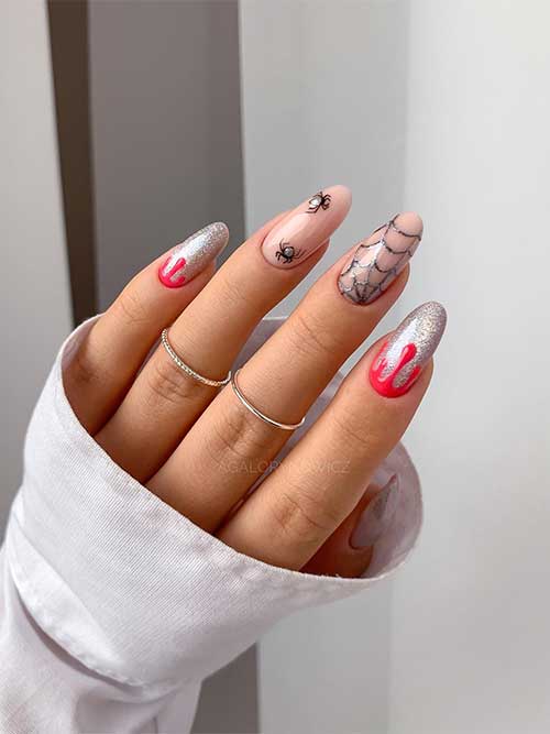 Long Silver glitter Halloween manicure with red drip nail art, a cobweb and spiders on two accent nude nails