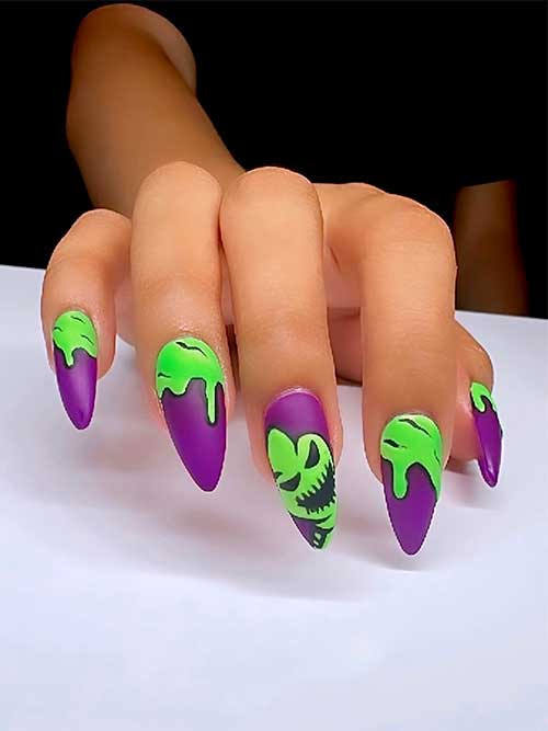 Long almond-shaped matte Halloween nails feature green boogie man nail art over a dark purple base color Long almond-shaped matte Halloween nails feature green boogie man nail art over a dark purple base color