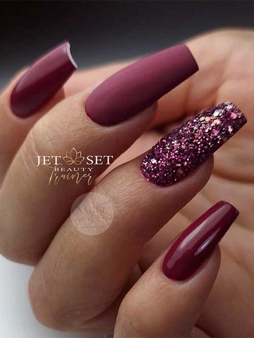 Long coffin glossy burgundy fall season nails with an accent matte nail and another burgundy glitter accent nail