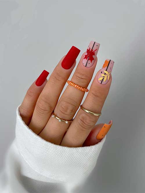 Matte burnt orange nails with an accent matte burnt yellow nail and two accent nude nails adorned with black speckles Matte burnt orange nails with an accent matte burnt yellow nail and two accent nude nails adorned with black speckles