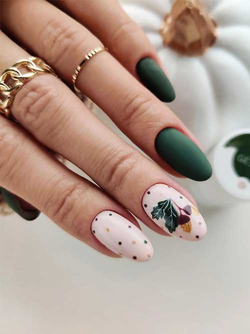 Matte dark green nails with two accent nude nails adorned with dark green and burgundy polka dots and dark green leaves