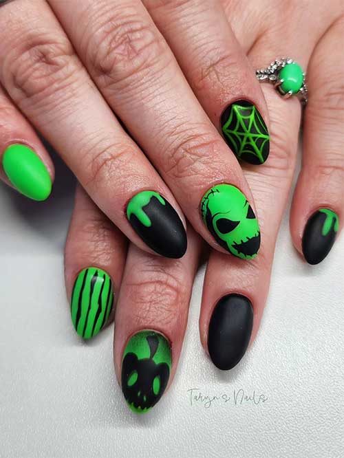 Short round-shaped matte black and green nails feature Oogie nail art, pumpkin, cobweb, and drip nail art