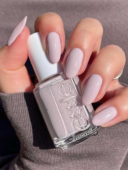 Essie Dance 'til Dawn it’s a muted gray white vegan nail polish with pink undertones from the Essie Fall 2023 collection