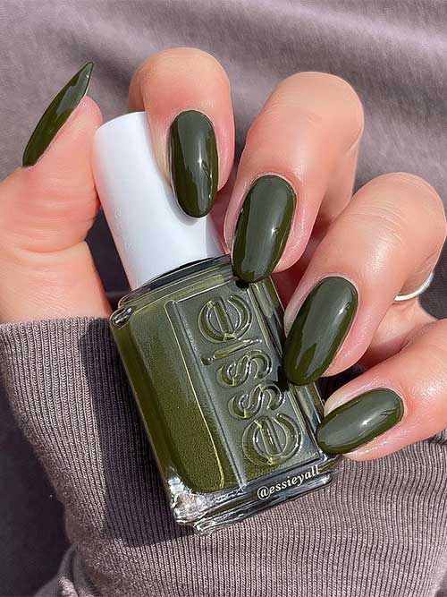 Essie meet me at midnight It’s a deep olive green vegan nail polish with yellow undertones from Essie fall 2023 collection