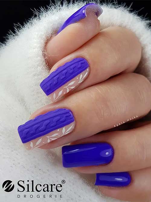 Medium square-shaped purple nails with two accent nails adorned with a sweater and white leaf nail art
