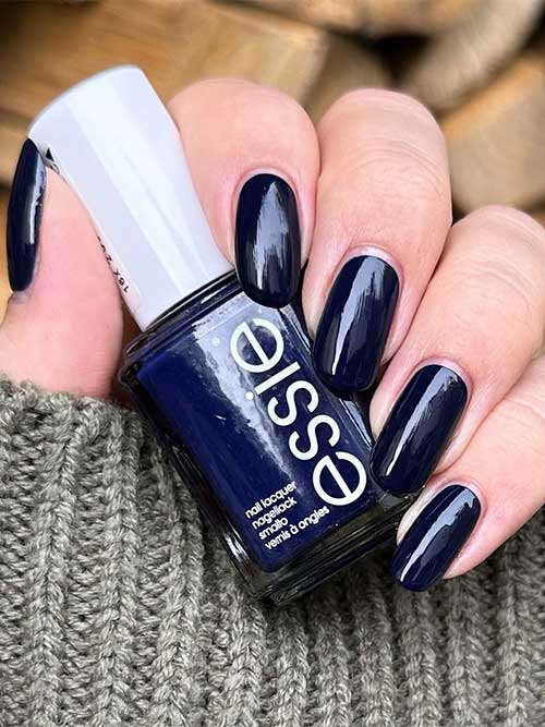 Step out of line it’s a richly dark indigo blue vegan nail polish with red undertones from the Essie fall 2023 collection Step out of line it’s a richly dark indigo blue vegan nail polish with red undertones from the Essie fall 2023 collection