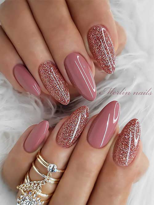 Almond-shaped dark nude New Year's nails with two accents rose gold glitter nails