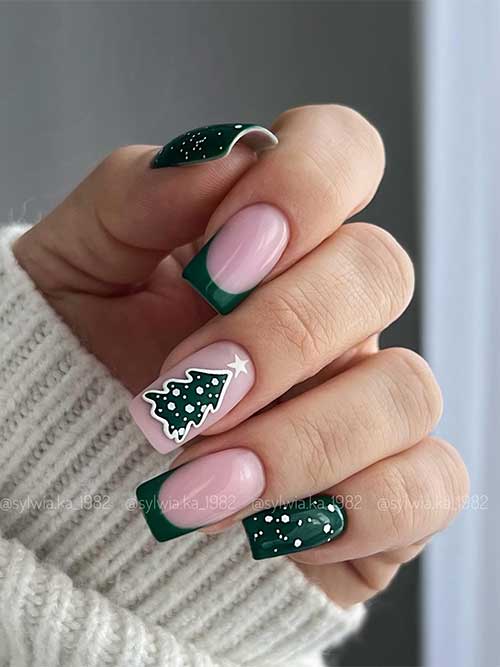 Dark green Xmas nails with big and small white dots as fallen snowflakes, two French tip nails, and a Christmas tree accent